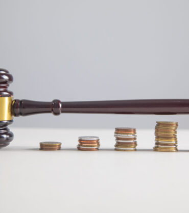 Judge gavel and coins on the table.