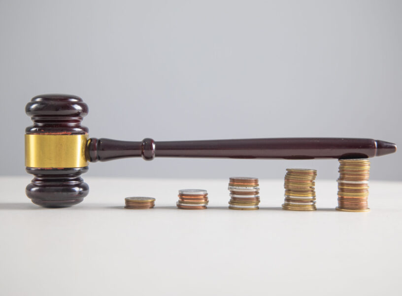 Judge gavel and coins on the table.