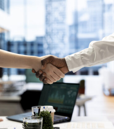 Recruiter shaking hands with person after finding best talent to fill open company position. HR department employee doing handshake with man after being happy with candidate skills and qualifications