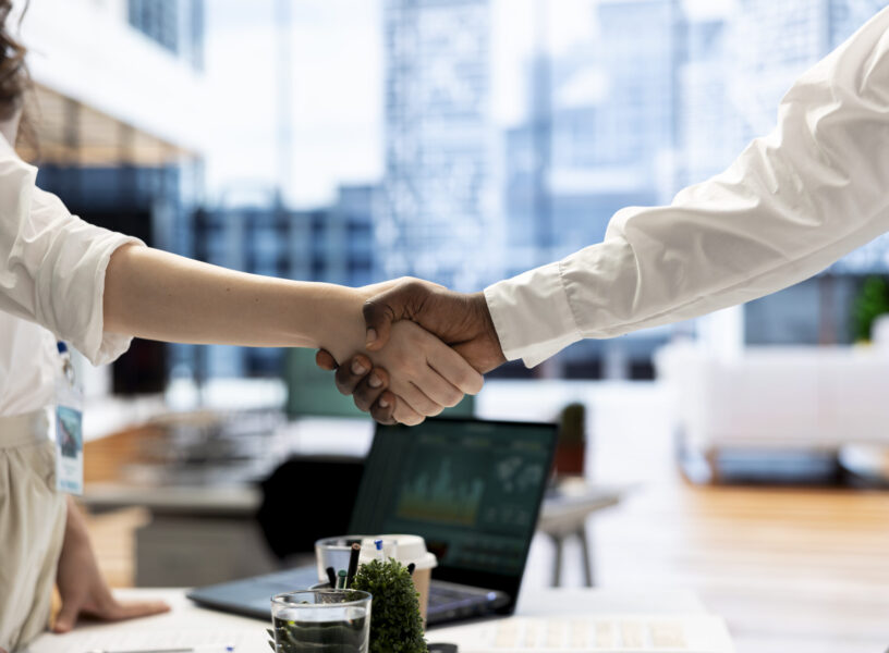 Recruiter shaking hands with person after finding best talent to fill open company position. HR department employee doing handshake with man after being happy with candidate skills and qualifications